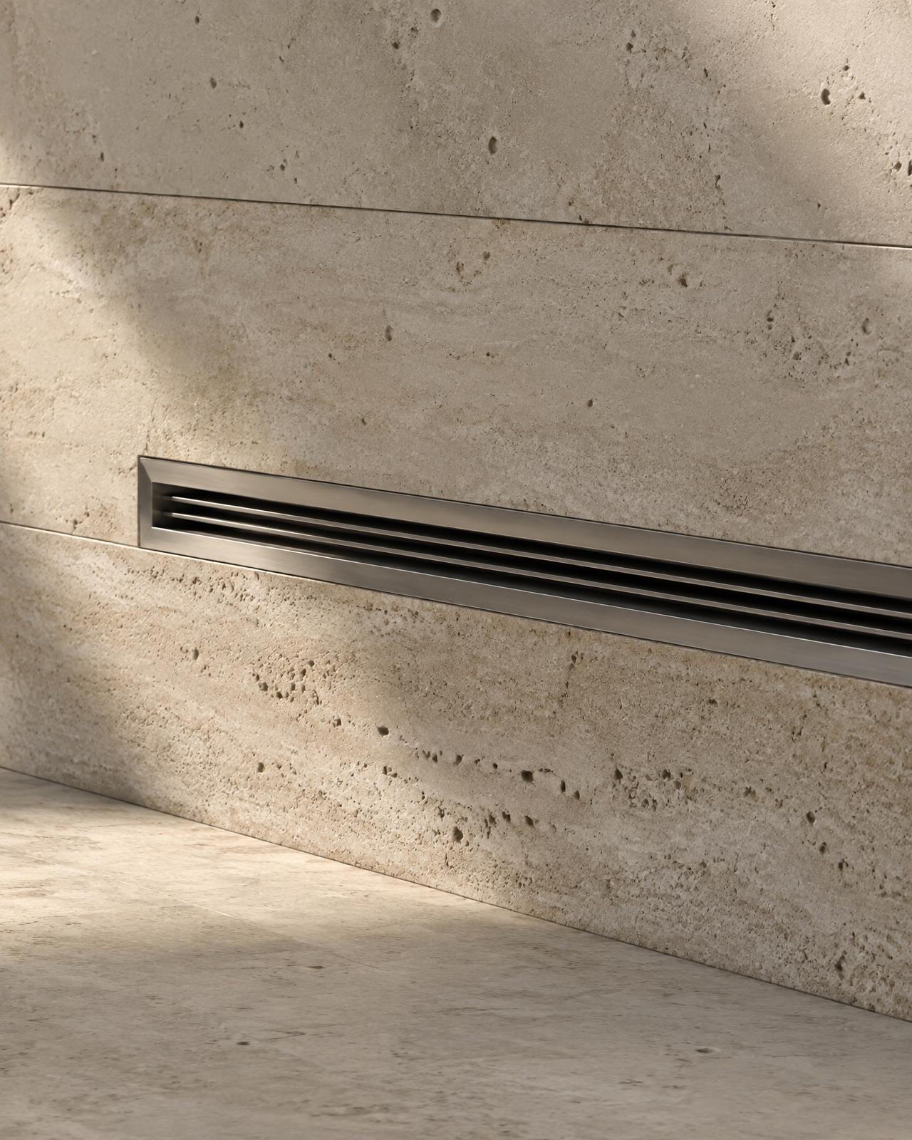 A brushed-metal diffusion slot recessed into a travertine wall